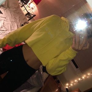 yellow cropped sweatshirt that says “sexy six”